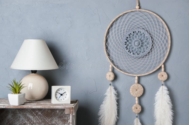 Gray beige dream catcher in bedroom interior on gray textured background. Bedroom decor. Gray beige dream catcher in bedroom interior on gray textured background. Bedroom decor