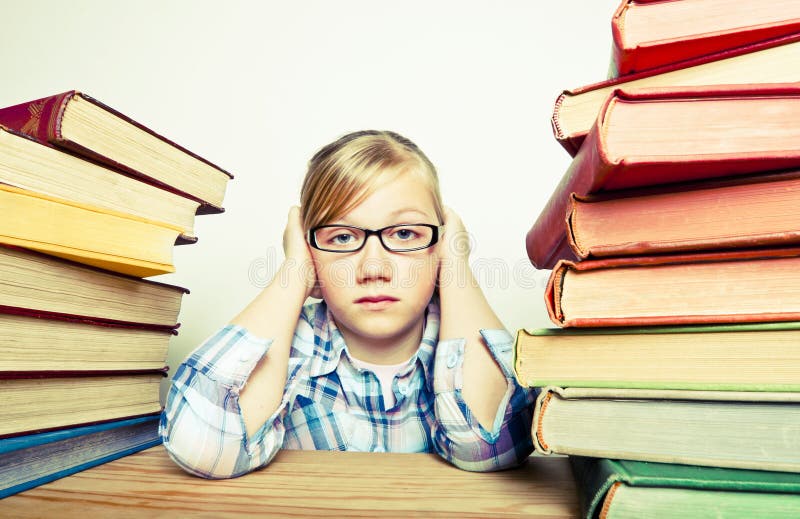 Concept image of a young stressed girl bored with homework. Concept image of a young stressed girl bored with homework