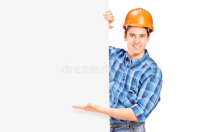 Travailleur de la construction posant derrière un panneau image libre de droits Travailleur de la construction posant derrière un panneau image libre de droits