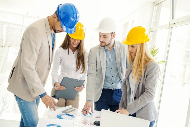 Travailleurs de la construction vérifiant les plans architecturaux images stock Travailleurs de la construction vérifiant les plans architecturaux images stock