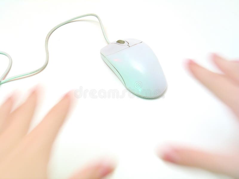 Hands (with motion blur) chasing after a regular computer mouse. High key and focus on mouse. Hands (with motion blur) chasing after a regular computer mouse. High key and focus on mouse.