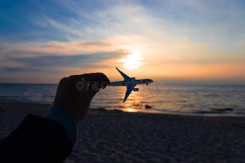 Travel and air transportation concept. Hand with small toy plane royalty free stock photo Travel and air transportation concept. Hand with small toy plane royalty free stock photo