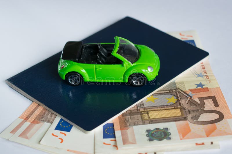 Travel by car. model car stand on passport and money. cheap expensive trip. vacation