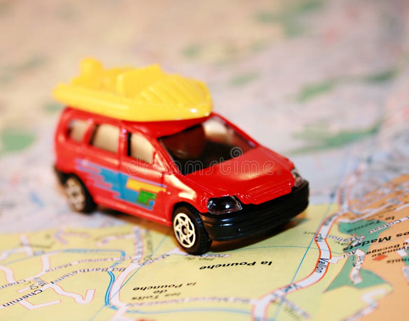 Holiday travel concept; a small car on a map. Holiday travel concept; a small car on a map