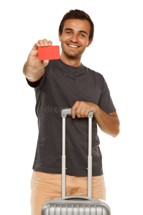 Young smiling male with suitcase showing empty credit card. Shallow depth of field, focus on credit card. Young smiling male with suitcase showing empty credit card. Shallow depth of field, focus on credit card.