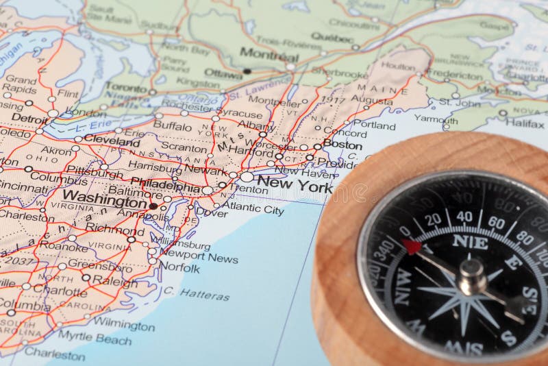 Compass on a map pointing at United States and planning a travel with destination New York. Compass on a map pointing at United States and planning a travel with destination New York