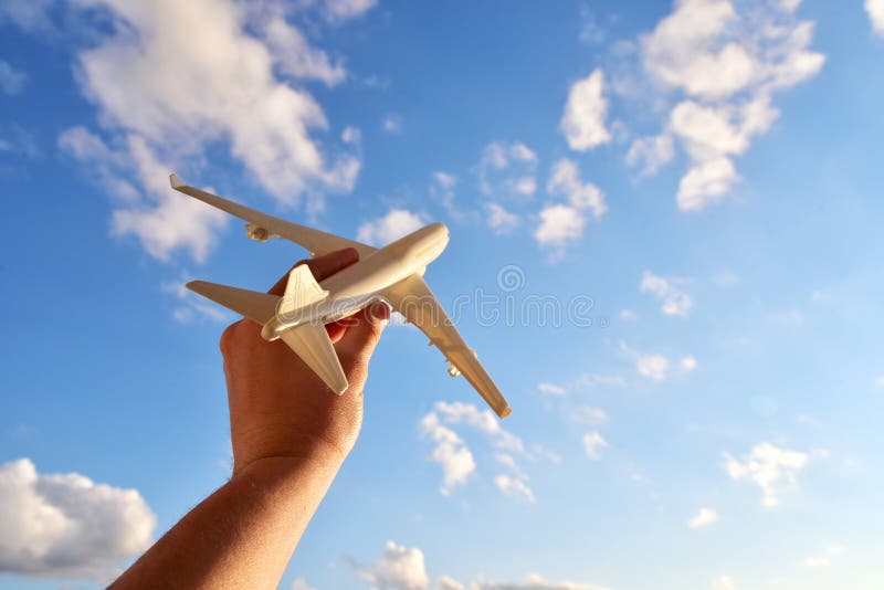 Travel and flight concept, airplane model in a man`s hand. Travel photography motivator for vacation