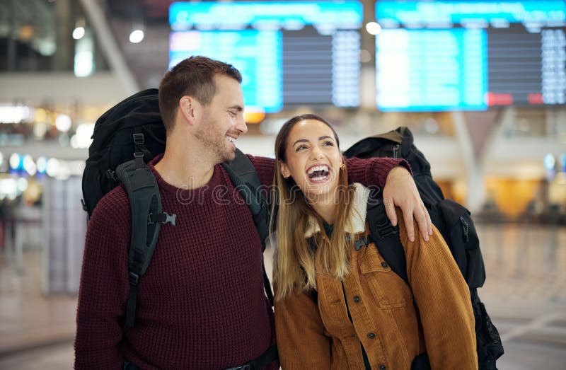 Travel, hug and couple at airport talking, chatting or laughing at comic or funny joke. Valentines love, thinking and royalty free stock photos