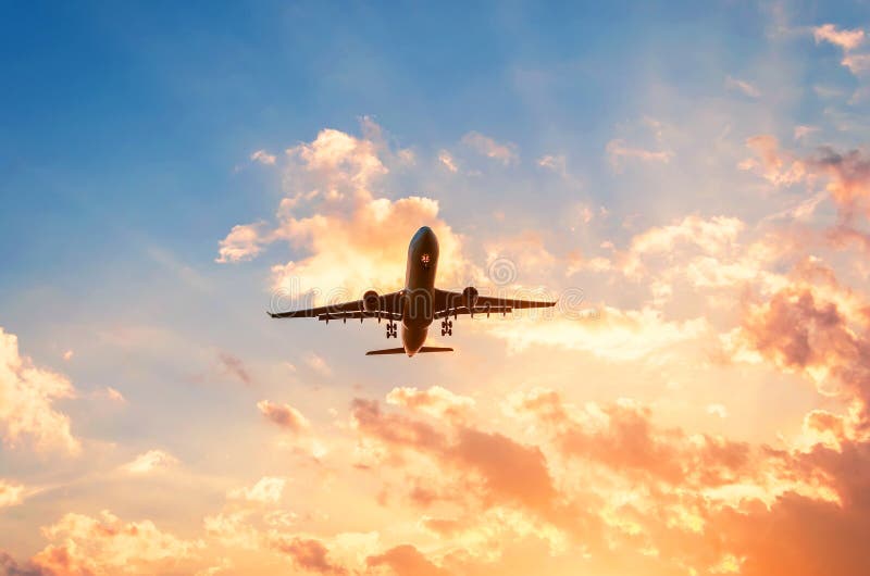 Travel by plane in a beautiful sky at sunset with clouds