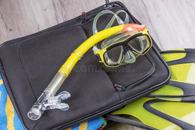 Travel set on suitcase with accessories for snorkeling