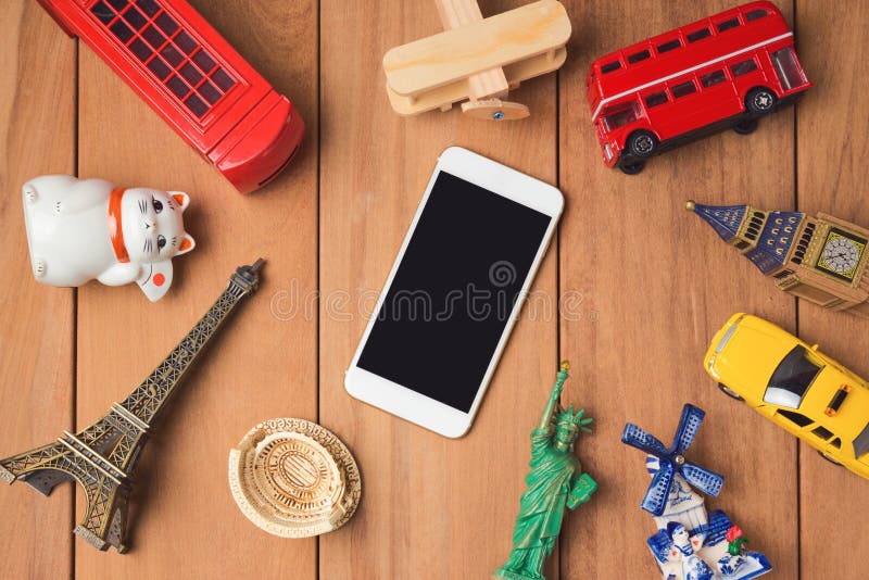 Travel and tourism concept with smartphone and souvenirs from around the world. royalty free stock images Travel and tourism concept with smartphone and souvenirs from around the world. royalty free stock images