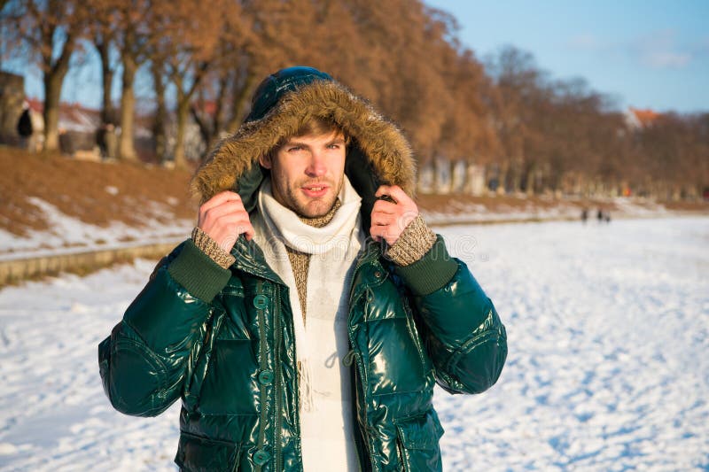 Travel and vacation concept. Winter outfit. Guy jacket hood. Man warm jacket snowy nature background. Wind resistant stock images Travel and vacation concept. Winter outfit. Guy jacket hood. Man warm jacket snowy nature background. Wind resistant stock images