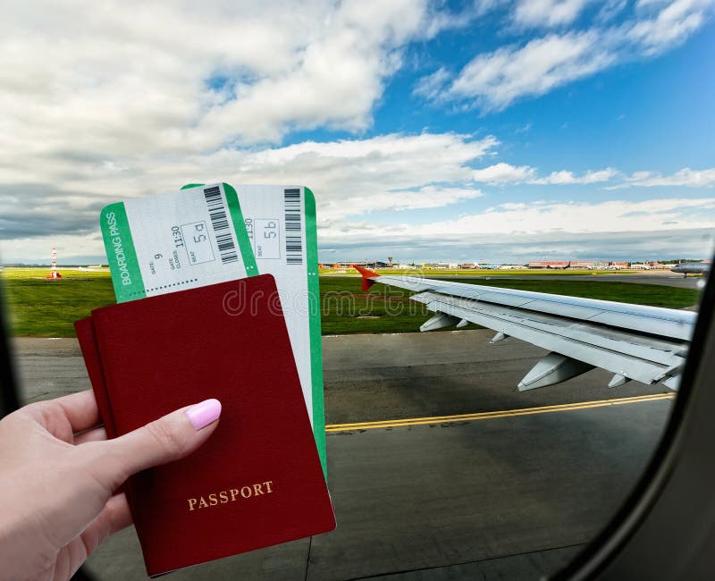 Travel vacation by plane. A female hand holds passports and tickets