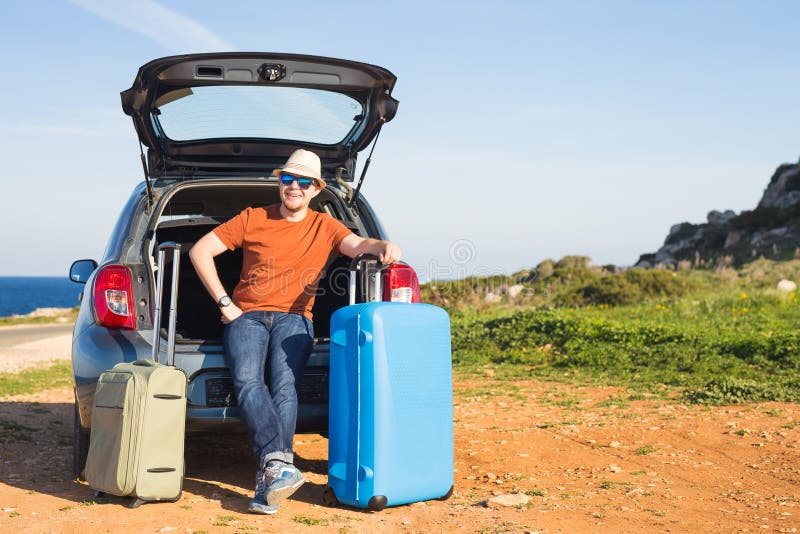 Travel, vacation, summer trip and people concept - man is going on holiday, suitcases in the trunk of a car. Couple, journey.