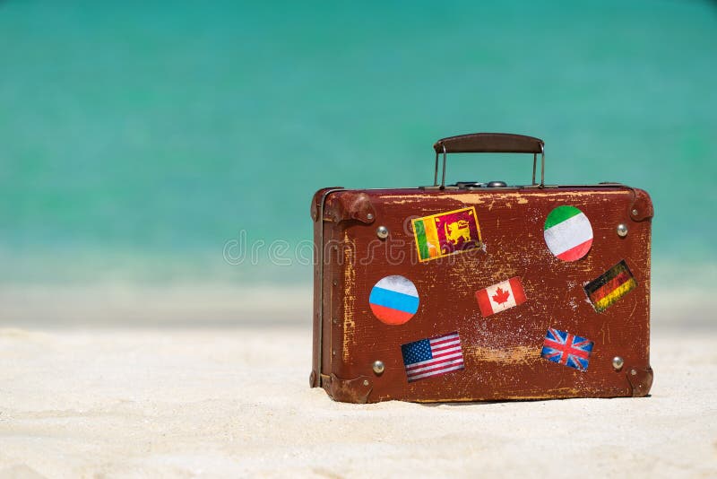 Travel vintage suitcase is alone on a beach