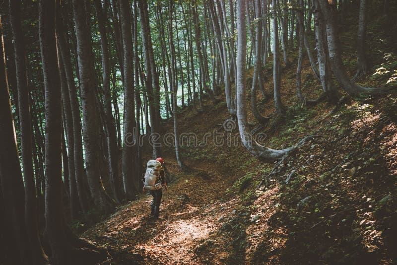 Traveler with backpack hiking in forest travel adventure healthy lifestyle. Trail outdoor summer active weekend eco tourism trip royalty free stock photo Traveler with backpack hiking in forest travel adventure healthy lifestyle. Trail outdoor summer active weekend eco tourism trip royalty free stock photo