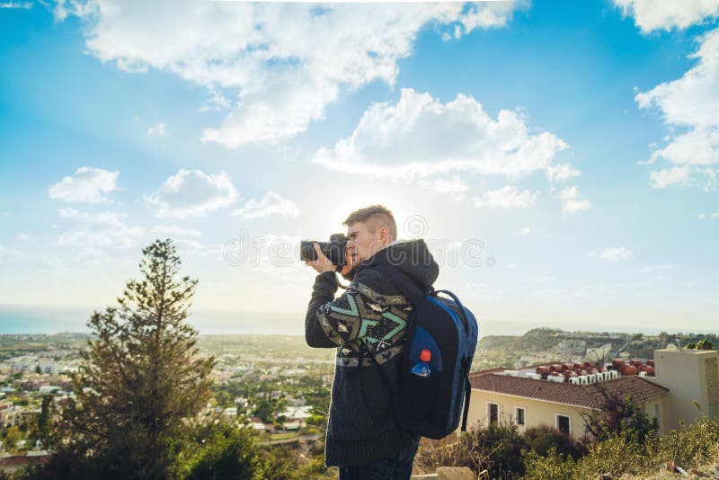 Traveler Photographer with Digital Camera on Top of the Mountain. Stock