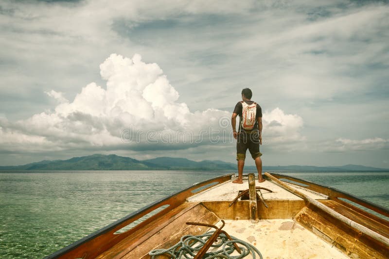 Traveler Standing on a Boat and Looking at the Islands Stock Photo