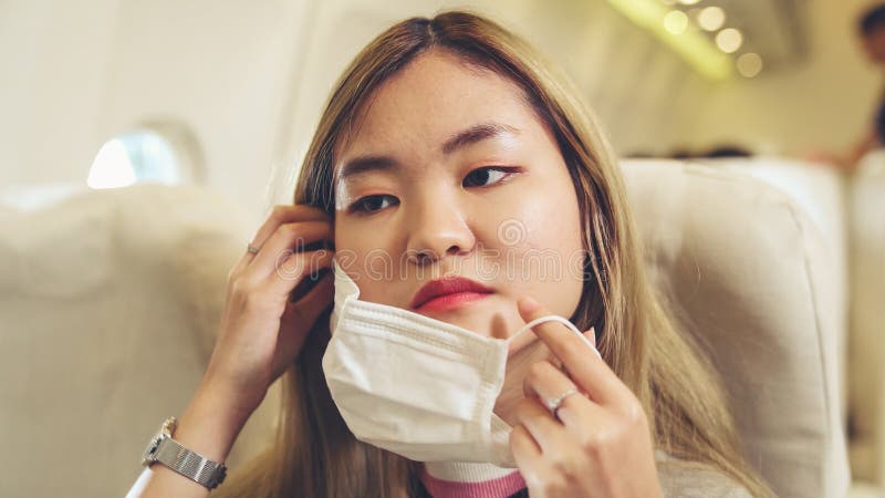 Traveler Wearing Face Mask while Traveling on Commercial Airplane ...