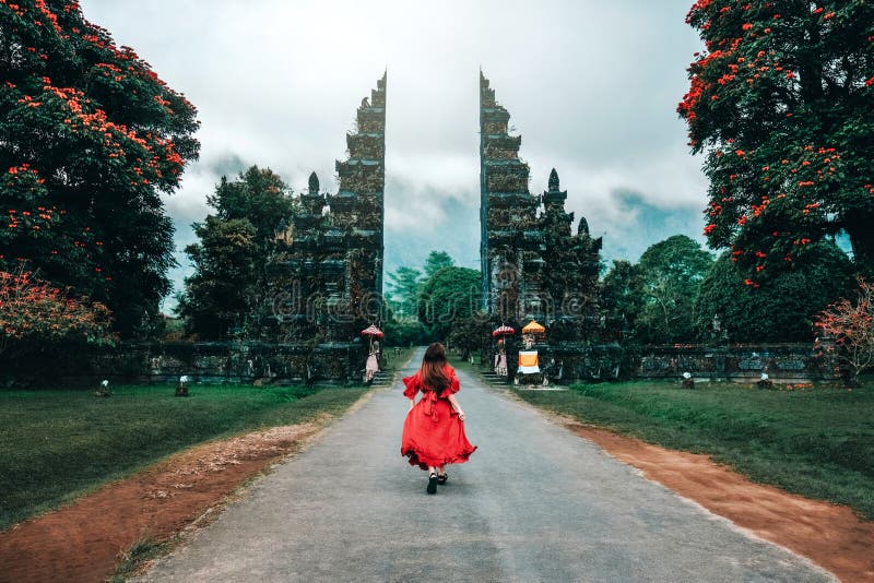 Traveler Woman Running at the Gates Hindu temple Bali, Indonesia stock photo Traveler Woman Running at the Gates Hindu temple Bali, Indonesia stock photo