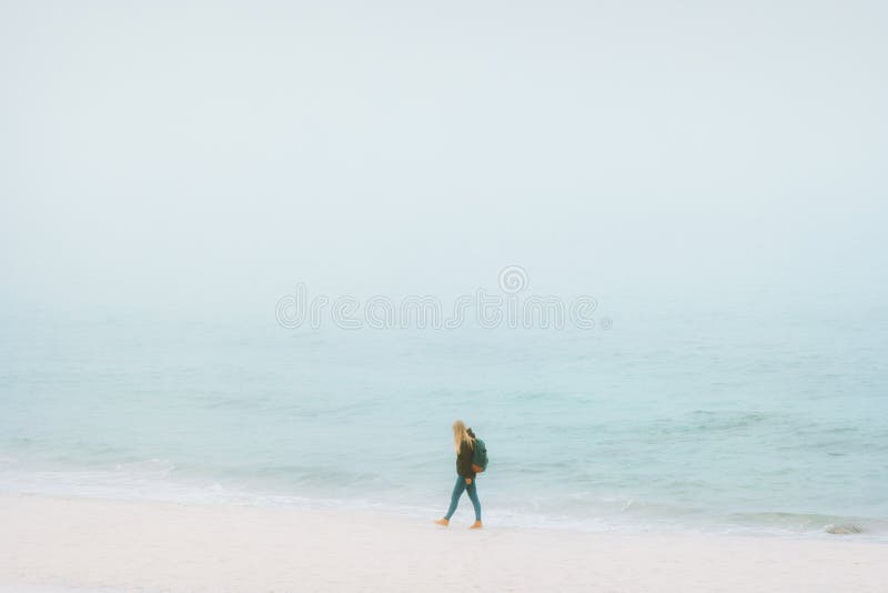 Traveler woman walking on beach Traveling alone