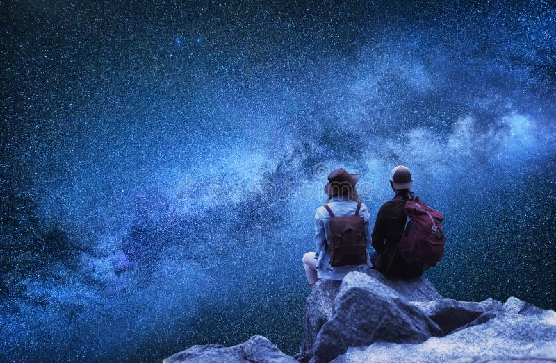 Travelers couple look at the stars. Travel and active life concept with team.