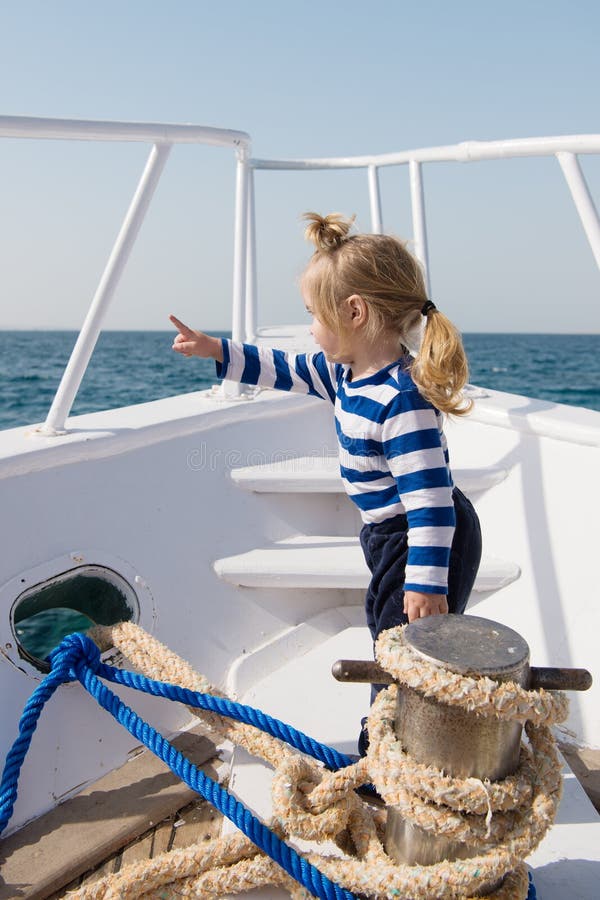 Traveling adventures and wanderlust. funny kid in striped marine shirt. happy little boy on yacht. boat trip by sea royalty free stock image Traveling adventures and wanderlust. funny kid in striped marine shirt. happy little boy on yacht. boat trip by sea royalty free stock image