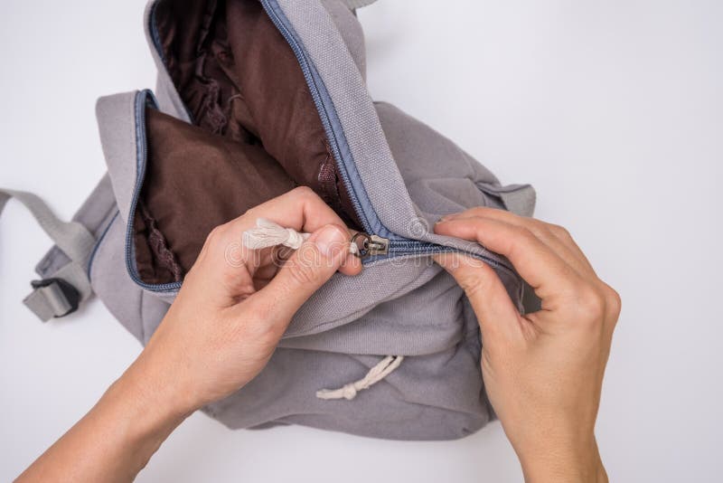 Traveller Hands Packing, Zipping the Zipper Lock on a Backpack Stock