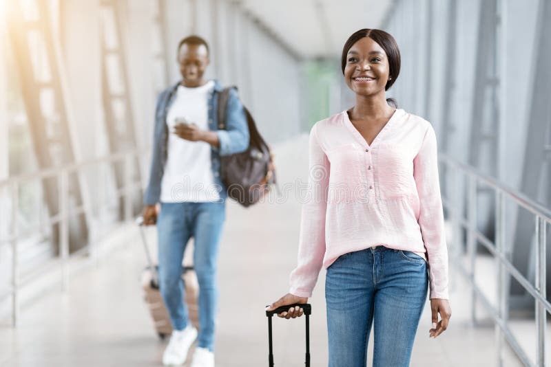 Travelling Concept. Happy Man and Woman Walking at Airport Terminal ...