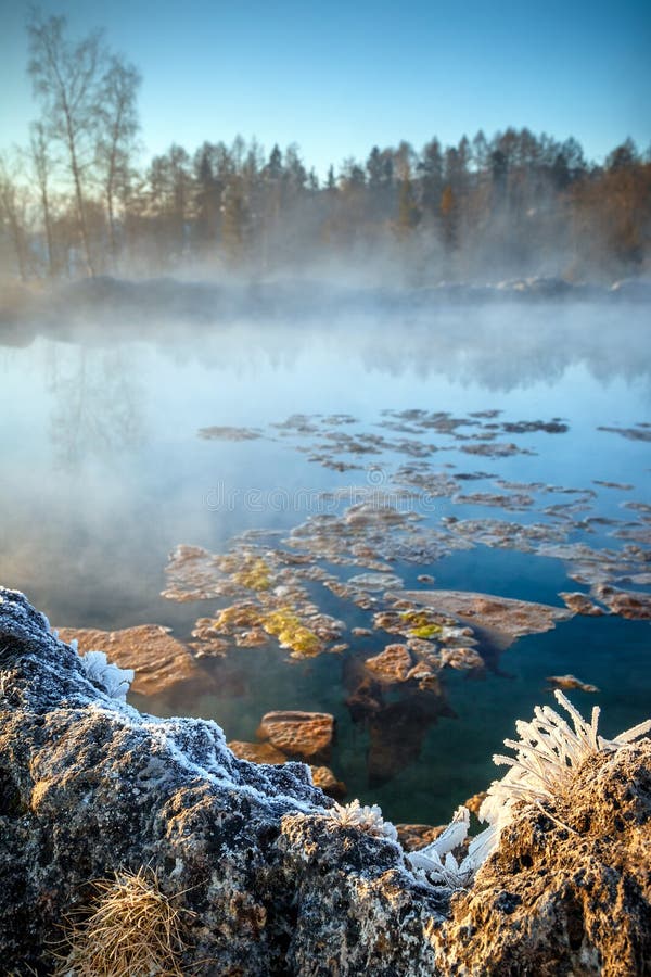 Travertine lake with hot water in winter,