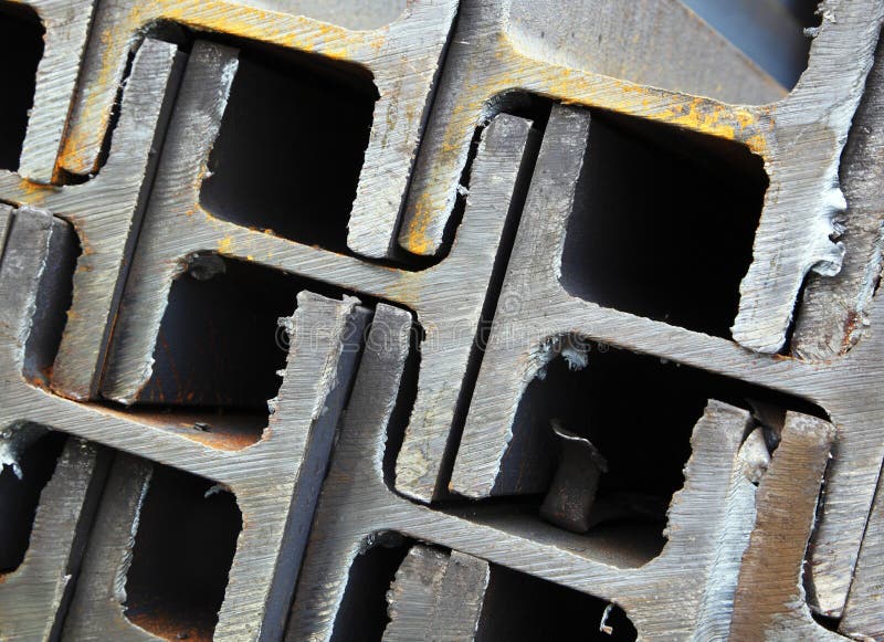 A closeup of interlocking or stacked steel I beams or girders used in building construction. A closeup of interlocking or stacked steel I beams or girders used in building construction.