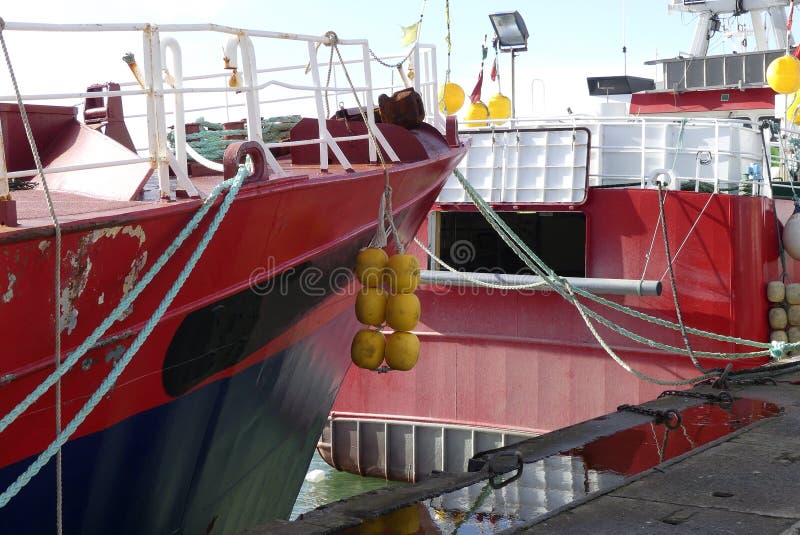 Details of bow and stern part of fishing boats moored at Lorient harbor, France. Details of bow and stern part of fishing boats moored at Lorient harbor, France.