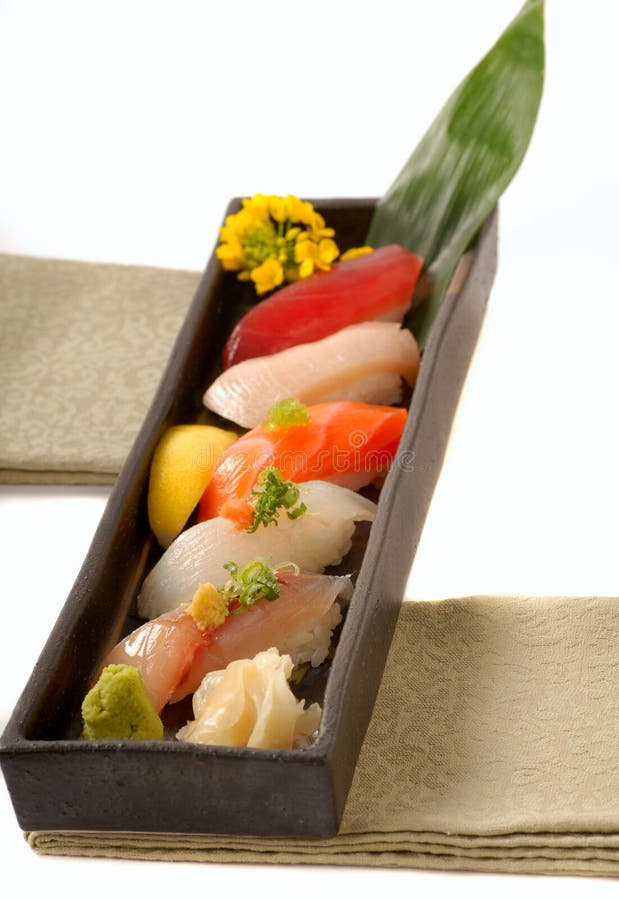 Tray of Asian sushi nigiri with lemon