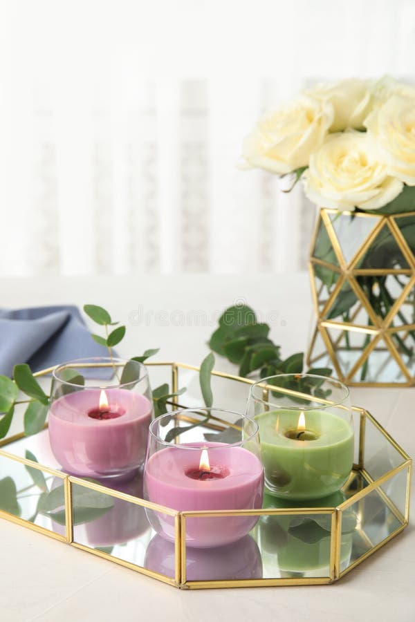 Tray with Burning Candles and Eucalyptus on Light Table Stock Image