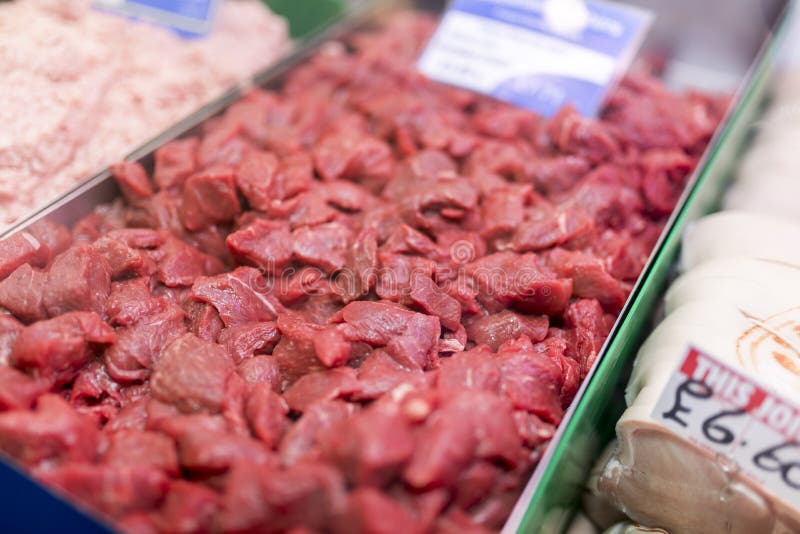 Tray of finest beef stewing steak laid out on a market stall in