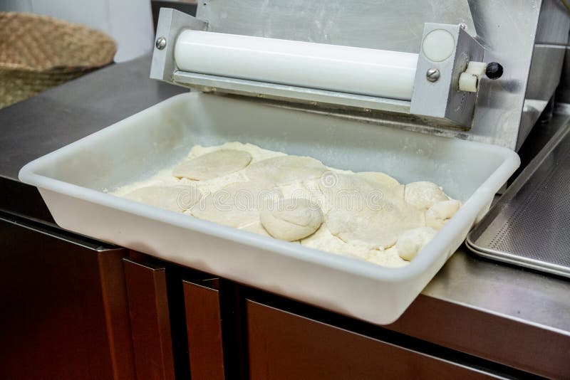 A Tray in a Restaurant Kitchen with Raw Mass and Flour Stock Photo