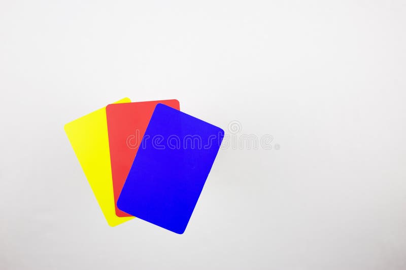 Three cards for football referee on a white table. Blue, red, yellow cards in football after changing the rules. Three cards for football referee on a white table. Blue, red, yellow cards in football after changing the rules