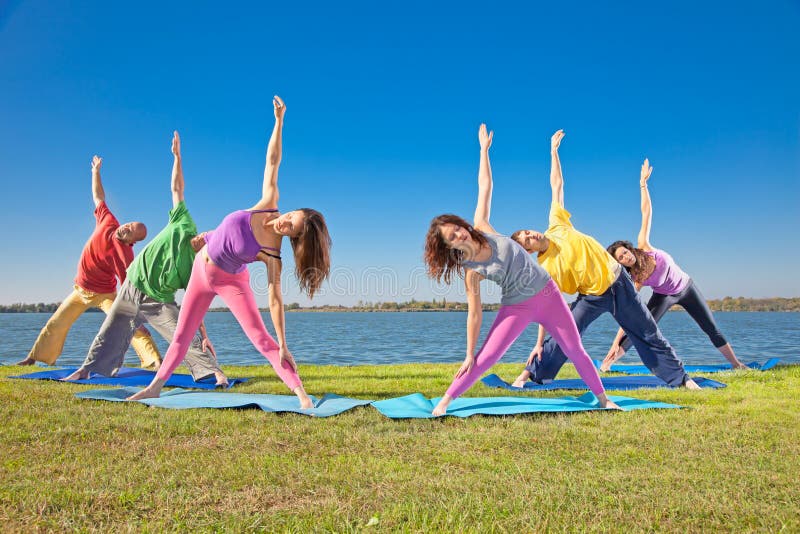 Tree couple , man and woman practice Yoga asana on lakeside.