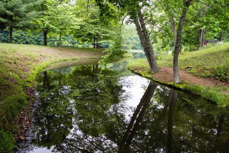 Trees reflected in the water of a winding river in Scioto Trail State Park in Chillicothe Ohio. Trees reflected in the water of a winding river in Scioto Trail State Park in Chillicothe Ohio