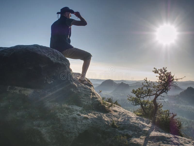Trekker in cowboy hat on mountain with Sunrise enjoy view stock images Trekker in cowboy hat on mountain with Sunrise enjoy view stock images