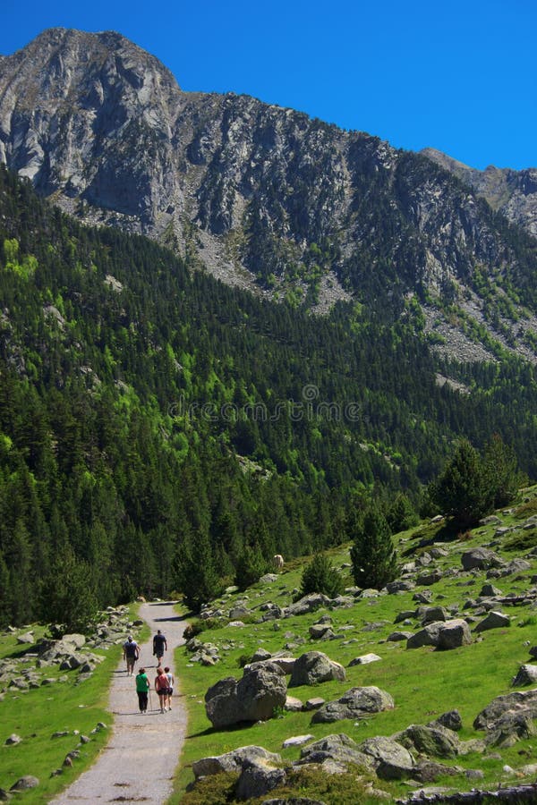 Group of trekkers walking in national park Aiguestortes, Spain. Group of trekkers walking in national park Aiguestortes, Spain