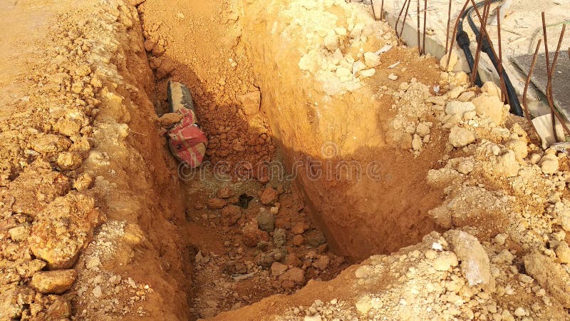 Trenches excavated at the construction site by construction workers to accommodate the utility services. royalty free stock image