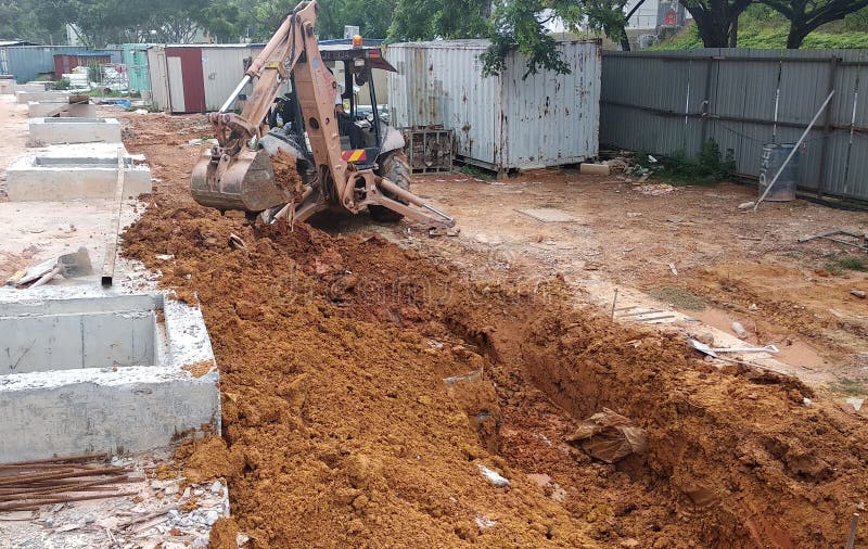 Trenches excavated at the construction site by construction workers to accommodate the utility services. stock photography