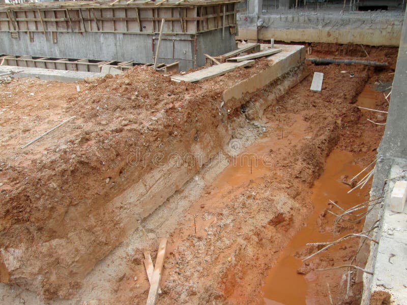 Trenches excavated at the construction site by construction workers to accommodate the utility services. royalty free stock image