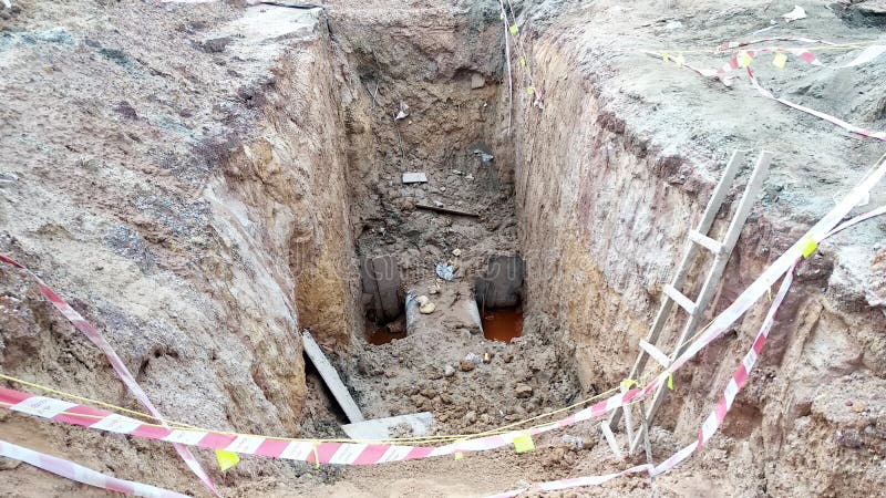 Trenches excavated at the construction site by construction workers to accommodate the utility services. royalty free stock photography