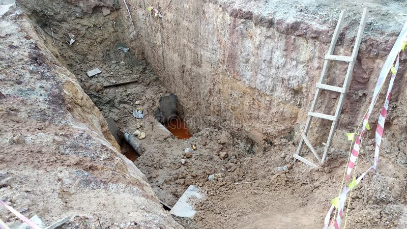 Trenches excavated at the construction site by construction workers to accommodate the utility services. stock photo