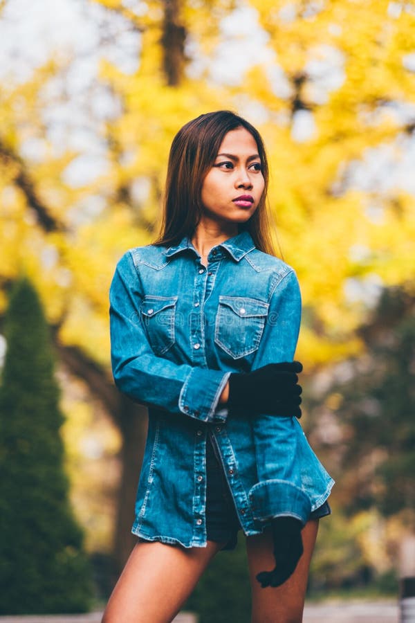 Trendig bärande jeans för ung kvinna klår upp med de höga kullarna och de långa bandknäsockorna Höstmodestil fotografering för bildbyråer Trendig bärande jeans för ung kvinna klår upp med de höga kullarna och de långa bandknäsockorna Höstmodestil fotografering för bildbyråer
