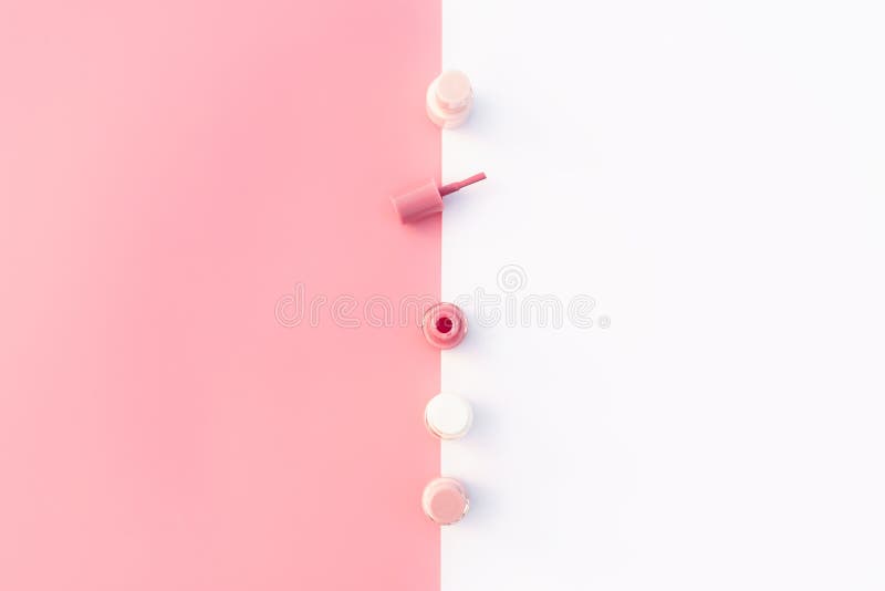 Trendy design template with pink nail polish layout on pastel pink and white background. Flat lay style. Copy space.