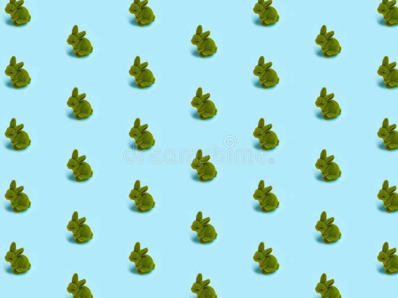 Trendy Easter pattern, little cute green grass rabbit, Easter bunny on bright light blue isolated background. Minimal Easter conce royalty free stock image Trendy Easter pattern, little cute green grass rabbit, Easter bunny on bright light blue isolated background. Minimal Easter conce royalty free stock image