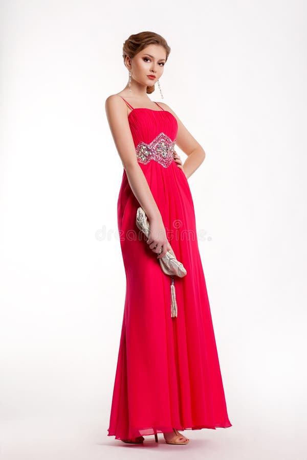 Trendy fashion model in long red dress posing